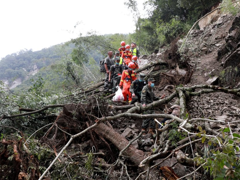 This photo taken on Sept 6, 2022 shows rescuers walking past uprooted trees from a landslide as they head to an earthquake-affected area following the earthquake that struck Sept 5, in Shimian county, Ya'an city, in China's southwestern Sichuan province.
This photo taken on Sept 6, 2022 shows rescuers walking past uprooted trees from a landslide as they head to an earthquake-affected area following the earthquake that struck Sept 5, in Shimian county, Ya'an city, in China's southwestern Sichuan province.