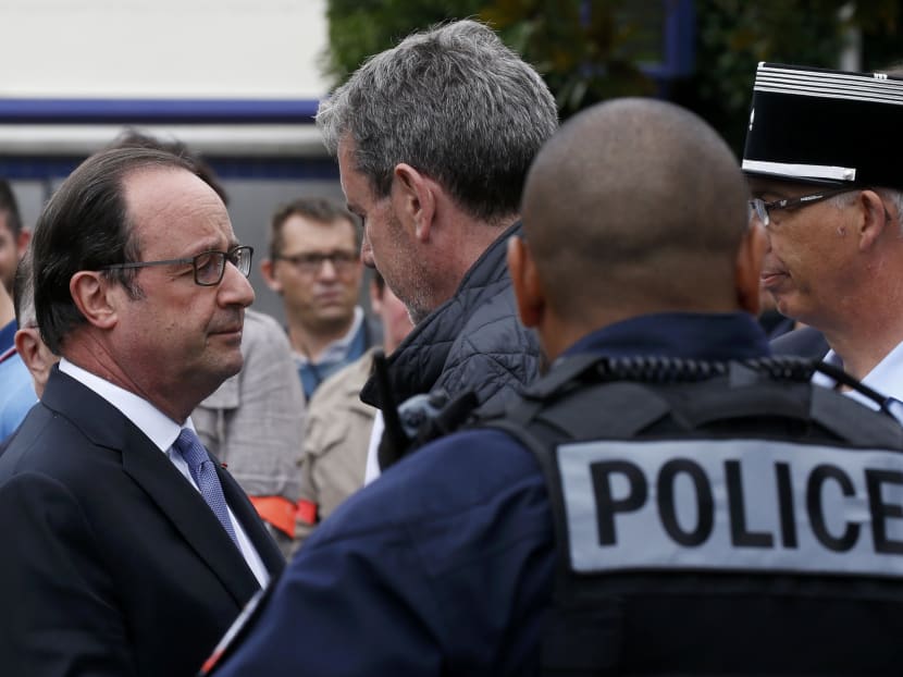 French President Francois Hollande (L) speaks with police forces after two assailants had taken five people hostage in the church at Saint-Etienne-du -Rouvray near Rouen in Normandy, France, July 26, 2016. Photo: Reuters