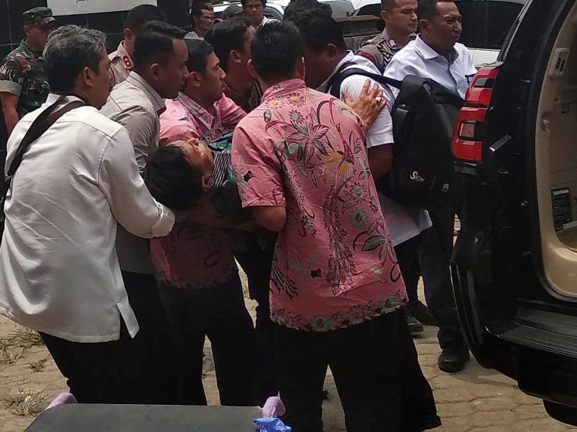 Indonesia's Chief Security Minister Wiranto is carried from a car to an emergency room after he was attacked in Pandeglang, Banten province, Indonesia, on Oct 10, 2019.