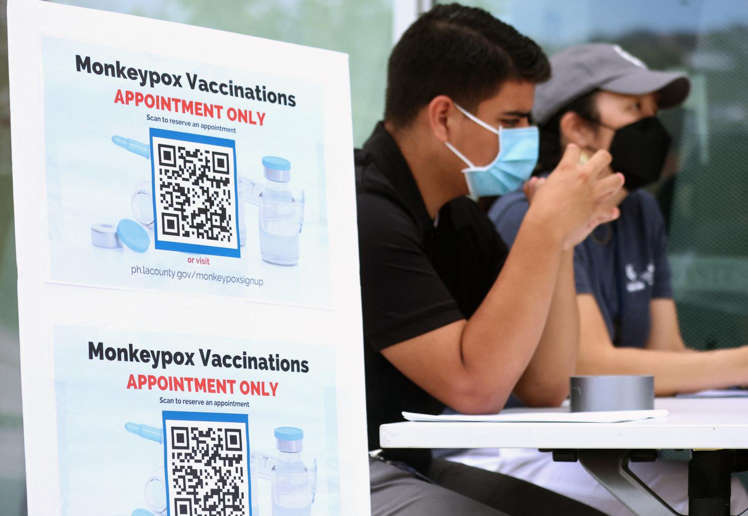 Health workers sit at a table at a pop-up monkeypox vaccination clinic at the West Hollywood Library on Aug 3, 2022 in West Hollywood, California.