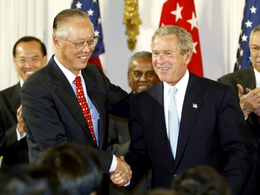 Then-United States President George W Bush and then-Prime Minister of Singapore Goh Chok Tong shake hands after signing the US-Singapore Free Trade Agreement (FTA) on May 6, 2003, the first FTA between Washington and an Asian country. Finance Minister Heng Swee Keat said that Singapore now has 21 FTAs. Photo: AFP