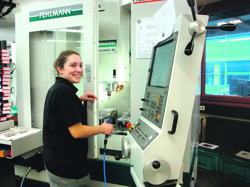 Automation technology apprentice Anna-Lena Kaizes tried out working in different departments and was mentored by an employee in German firm Festo. Photo: Ng Jing Yng
