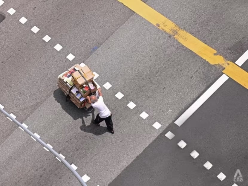 An elderly man pushing a pushcart across the street at South Bridge Road in Singapore on Feb 22, 2022.