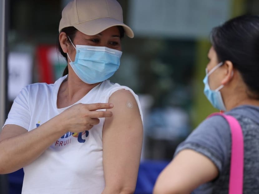 Domestic helpers get inoculated at a vaccination centre in Sai Ying Pun, Hong Kong.