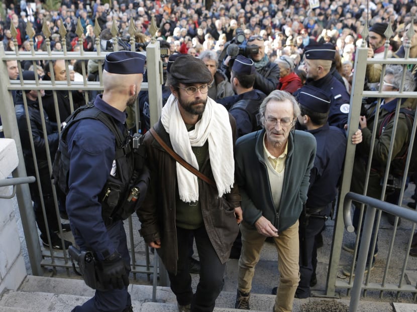 A French activist farmer Cedric Herrou (centre) is charged of helping illegal migrants enter France, travel in France and stay in France. AP