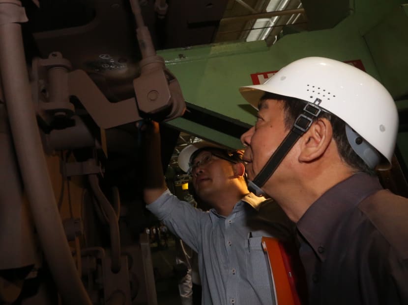 Transport Minister Khaw Boon Wan inspecting a fixed bolster on an SMRT train that has a hairline crack, at Bishan Depot on July 12, 2016. TODAY file photo