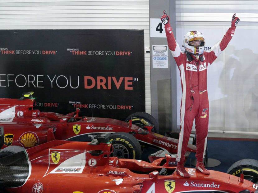 Ferrari's Sebastian Vettel celebrates winning the Singapore Grand Prix yesterday. Photo: Jason Quah