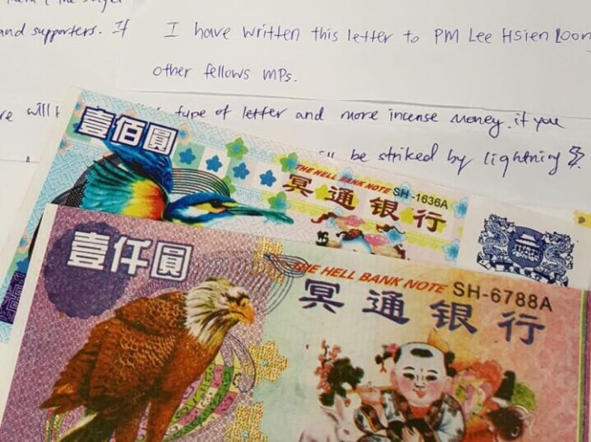 Hell notes are seen along with a letter addressed to Prime Minister Lee Hsien Loong and MPs.