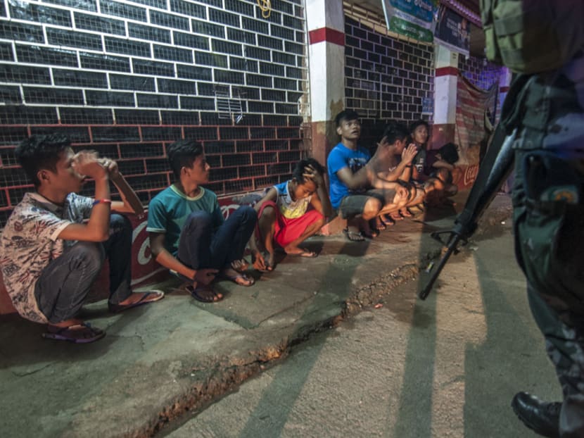 Iligan police line up citizens caught loitering in the streets after curfew hours. The local government has enacted curfew hours after President Rodrigo Duterte declared martial law on the island of Mindanao. Photo: Luis Liwanag/TODAY