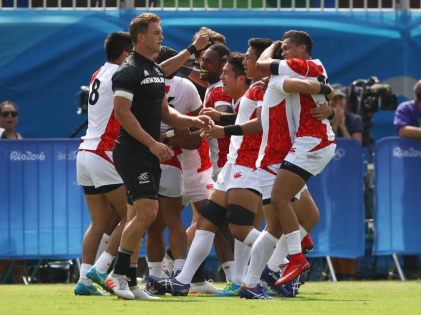 Japanese players celebrating after their shock win over New Zealand. Photo: Getty Images
