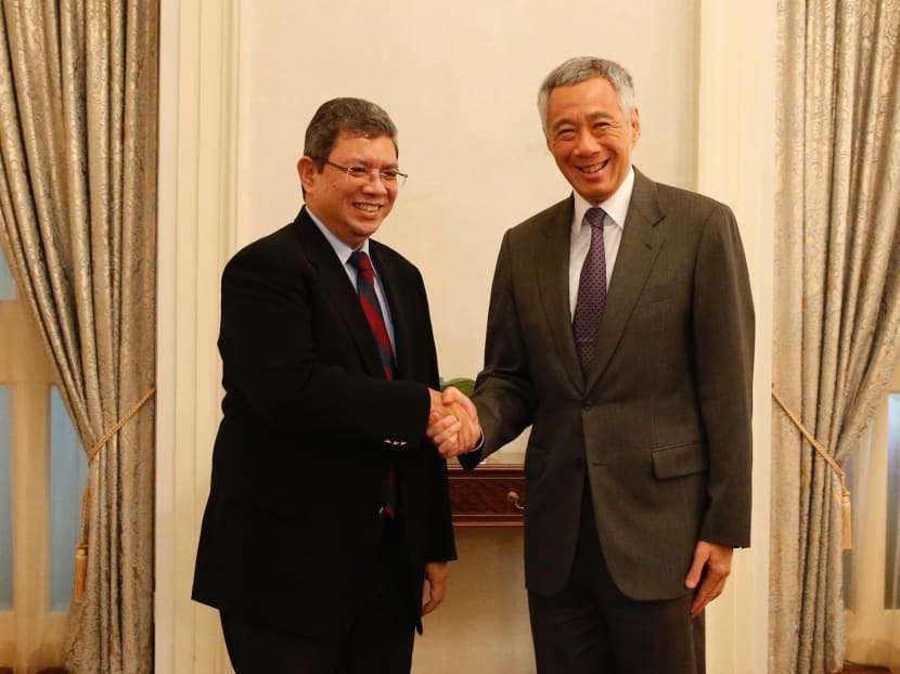Malaysian Foreign Minister Saifuddin Abdullah and Prime Minister Lee Hsien Loong at the Istana on Monday, July 30, 2018.