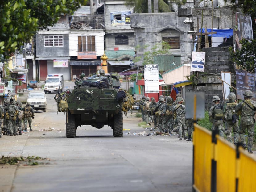 Philippine marines walking to the frontline to retake control of some areas of Marawi city yesterday. About 2,000 of the city’s 200,000 residents remain trapped in areas controlled by the militants. Photo: AP