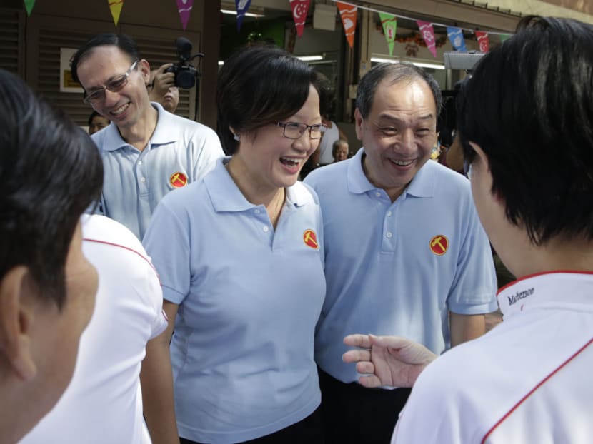 The Workers' Party Secretary General, Low Thia Khiang (R) and Chairman Sylvia Lim (L)  having a light moments with PAP supporters at Blk 89 Circuit Road food centre on 07 Aug 2015. Photo: Wee Teck Hian/TODAY