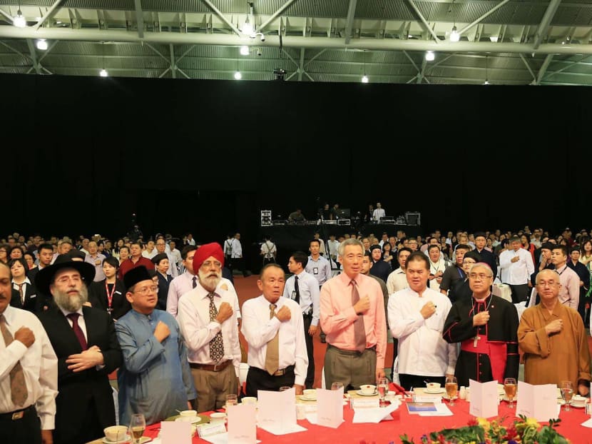 Prime Minister Lee Hsien Loong (centre) taking the pledge with various religious leaders at a Taoist Federation silver jubilee dinner in April. If leaders subscribe to any faith, it is crucial to draw a line between their personal beliefs and professional work. TODAY file photo