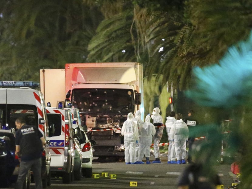 French police forces and forensic officers stand next to a truck July 15, 2016 that ran into a crowd celebrating the Bastille Day national holiday on the Promenade des Anglais killing at least 60 people in Nice, France, July 14, 2016. Photo: Reuters