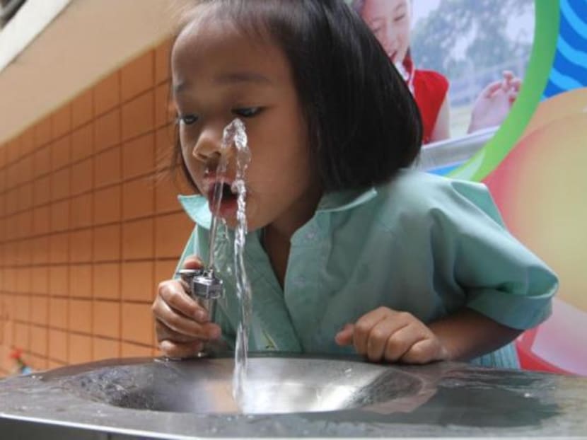 A schoolgirl drinks from a fountain installed as part of an Abhisit government project to show that Bangkok tapwater was safe to drink. Soon, it will probably also be salty. Photo: Bangkok Post