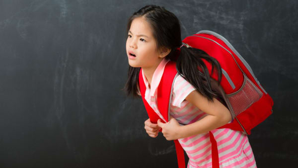 Can poor posture and heavy bags really cause scoliosis in children – or is it something else?