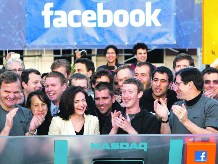 In this image provided by Facebook, Facebook founder, Chairman and CEO Mark Zuckerberg, center, applauds at the opening bell of the Nasdaq stock market, Friday, May 18, 2012, from Facebook headquarters in Menlo Park, Calif.  Photo: AP