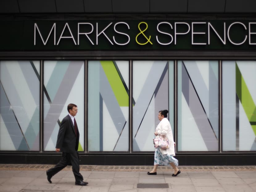 Pedestrians walk past an M&S shop in northwest London. Reuters file photo