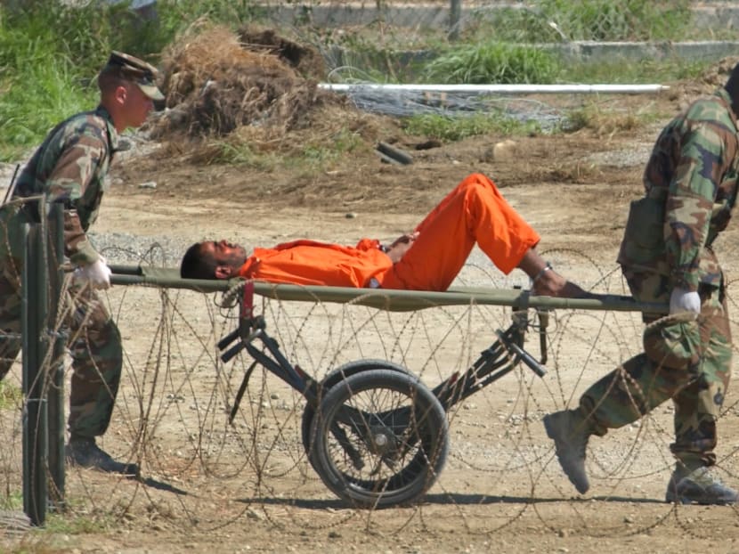 A detainee from Afghanistan is carried on a stretcher before being interrogated by military officials at the detention facility Camp X-Ray on Guantanamo Bay US Naval Base in Cuba. AP file photo