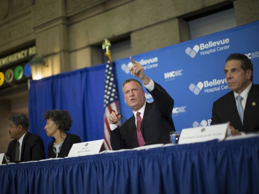 New York City Mayor Bill de Blasio (second from right) speaks during a news conference at Bellevue Hospital to discuss Craig Spencer, a Doctors Without Borders physician who recently returned to the city after treating Ebola patients in West Africa, Oct 23, 2014, in New York. Photo: AP
