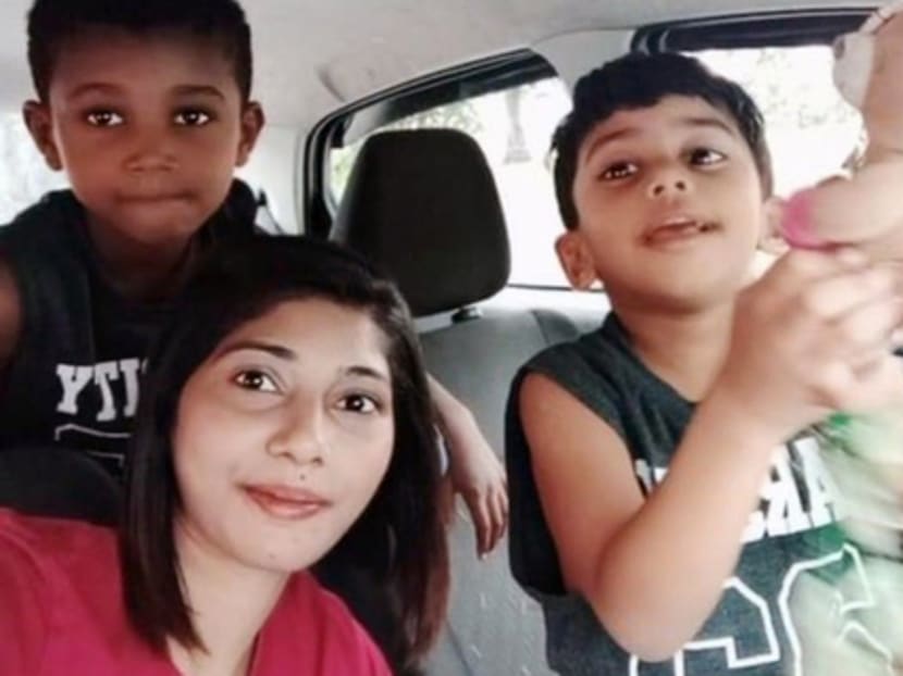 Ms Nafisah Alahu, a Malaysian still stuck in Singapore, pictured in pre-pandemic times with her two sons, now aged five and eight, whom she has not seen in close to two years.