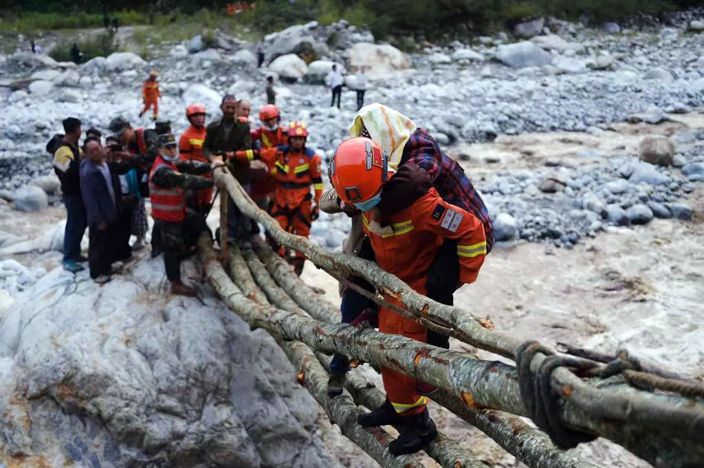 This photo taken on Sept 5, 2022 shows rescue workers evacuating residents after a 6.6-magnitude earthquake in Luding county, Ganzi, in China's southwestern Sichuan province.
