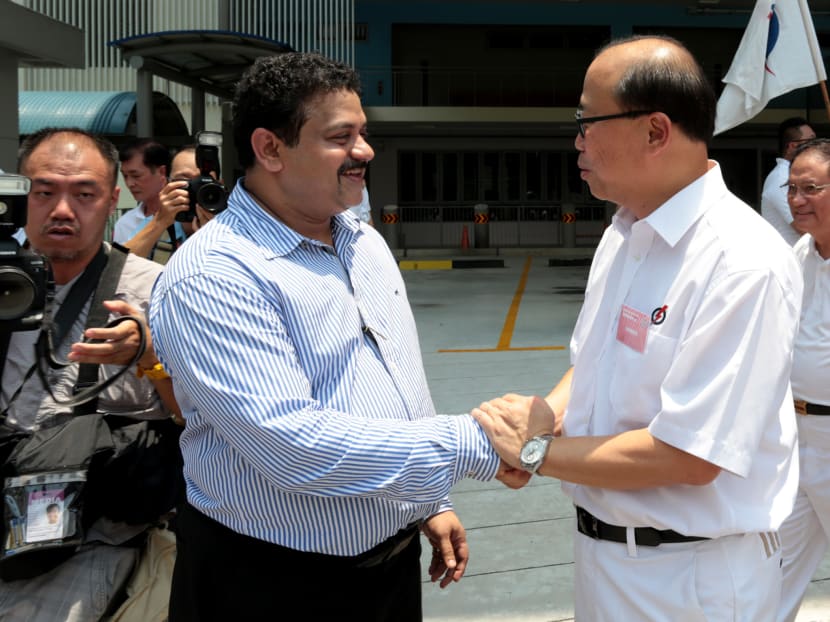 Independent candidate for Bukit Batok SMC Samir Salim Neji, 45, shakes hands with PAP's David Ong who is contesting the SMC as well. Photo: Jason Quah