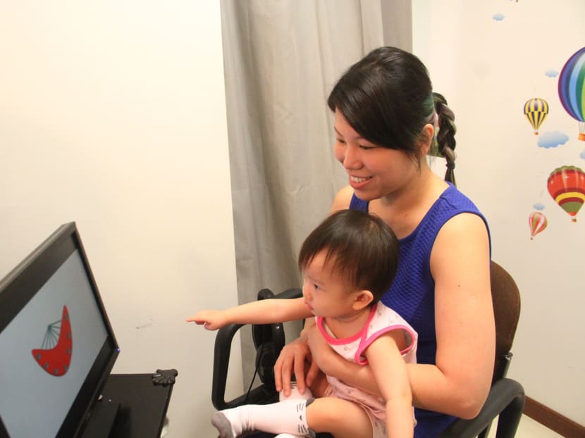 Ms Tricia Wong and daughter Zelene during a demo of the study at NUS. The findings probably apply to other language pairings, said researcher Leher Singh. Photo: Damien Teo