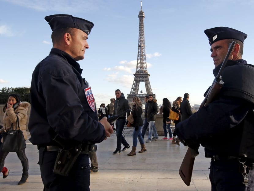 French police officers stand guard by the Eiffel tower a week after a series of deadly attacks in the French capital Paris, France, on Nov 22, 2015.  Photo: Reuters