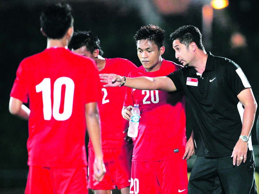 If Singapore fail to get past Laos in the opening match tomorrow, a tough ride in the hunt for that elusive first SEA Games gold medal beckons for coach Aide Iskandar’s (right) players. TODAY file photo