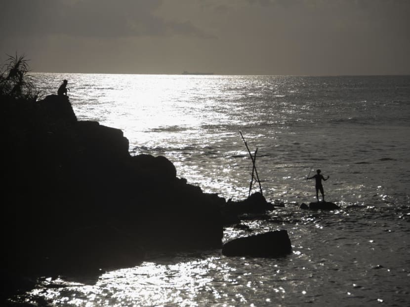 A man fishes at the Indian ocean in Ahangama on Dec 30, 2021.