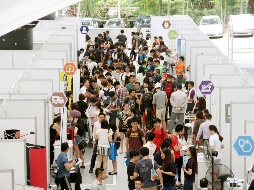 Applicants at a job fair at Singapore Polytechnic. Analysts predict that companies are unlikely to grow headcounts as they take a wait-and-see approach. PHOTO: DARYL KANG