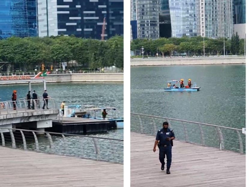 A montage of screen grabs of a video clip taken by passerby Richie Tay showing rescuers retrieving the body of a man in Marina Bay on Dec 25, 2021.
