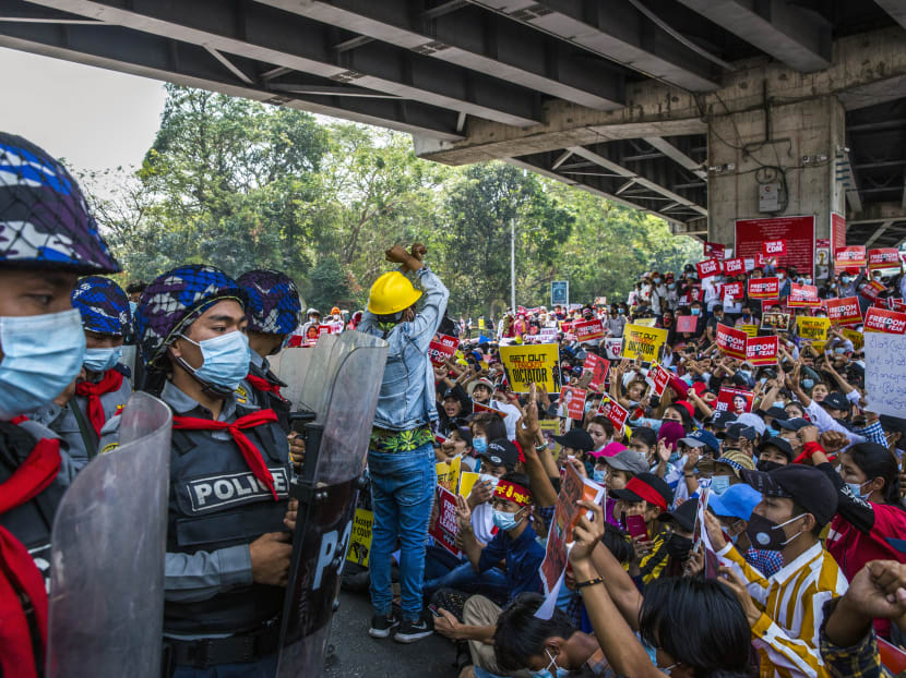 Police in riot gear look on as demonstrators protest against the military coup in Yangon, Myanmar. The military has sought to crack down on internet usage in part to keep protesters from organising. Police in riot gear look on as demonstrators protest against the military coup in Yangon, Myanmar. The military has sought to crack down on internet usage in part to keep protesters from organising.