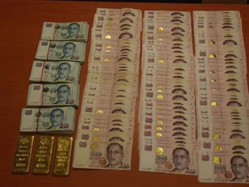 S$860,000 seized from suspected football betting syndicates. Photo: Singapore Police Force