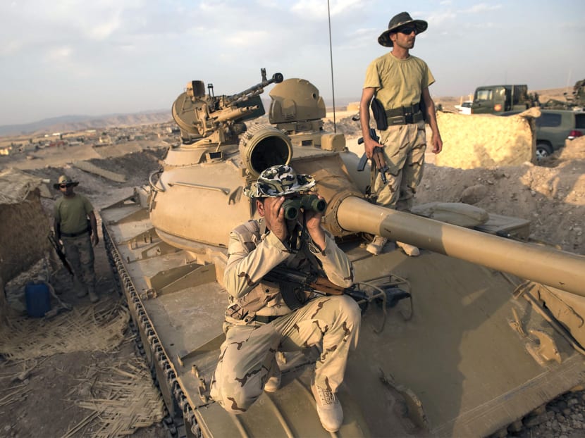 Kurdish Peshmerga fighters near the Mosul Dam in northern Iraq on Monday. Kurdish and Iraqi forces took control of the main dam compound on Monday, but fighting continued at the site of a separate dam, officials said. 
PHOTO: THE NEW 
YORK TIMES