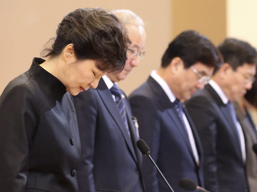 South Korea's President Park Geun-hye (L) pays silent tribute to victims of sunken passenger ship Sewol, before a cabinet meeting at the presidential Blue House in Seoul April 29, 2014. More than 300 people, most of them students and teachers from the Danwon High School, are dead or missing presumed dead after the April 16 disaster. The ferry sank on a routine trip from the port of Incheon, near Seoul, to the southern holiday island of Jeju. Photo: Reuters