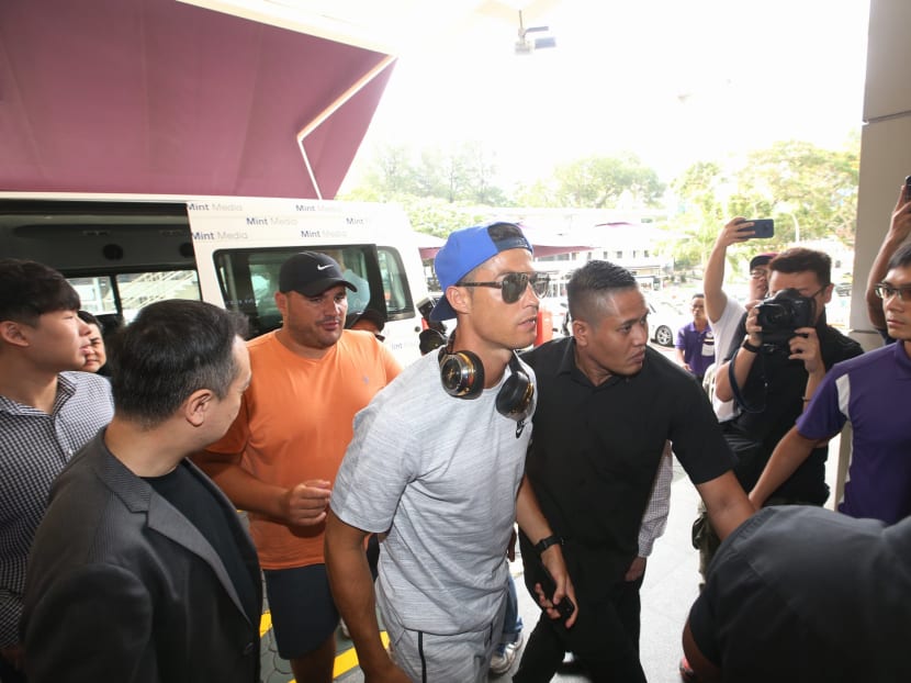 Cristiano Ronaldo being surrounded by his minders as he makes his way into Thomson Medical Centre to visit Kim Lim, the daughter of Singapore billionaire Peter Lim. Photos: Koh Mui Fong/TODAY
