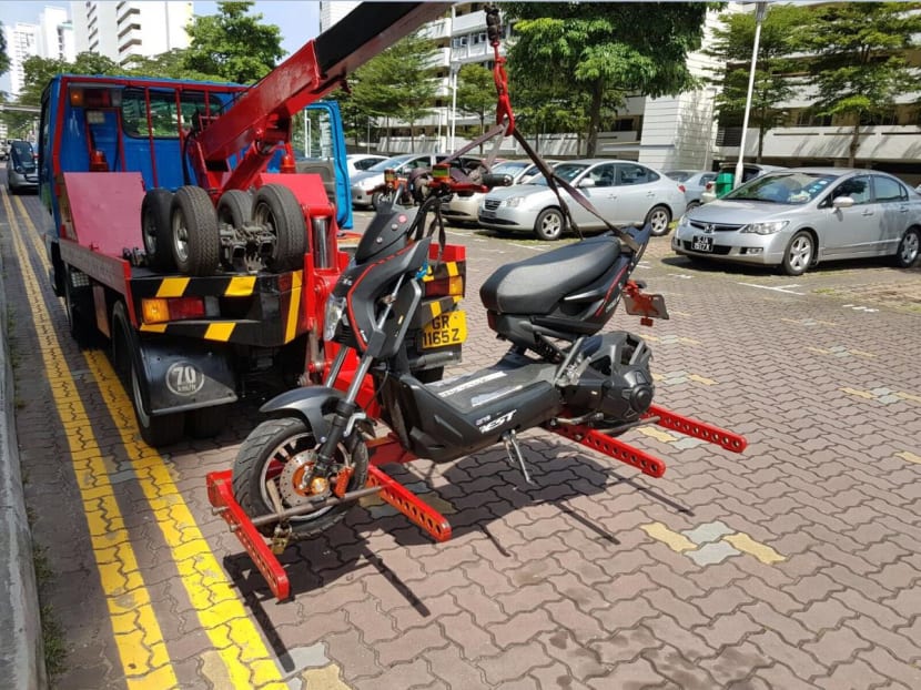 A Personal Mobility Device (PMD) being impounded after a rider rode it on the road. Photo: LTA via Facebook