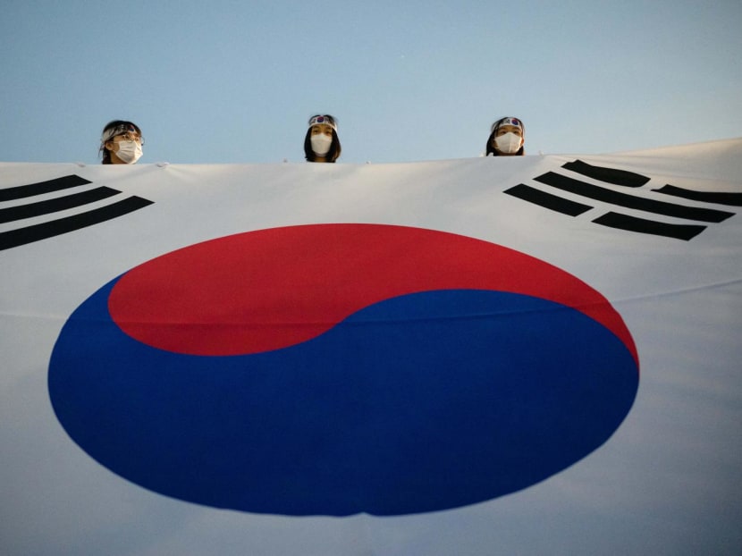 Participants hold a huge flag at the front of a fire torch parade during celebrations for the March 1 Independence Movement anniversary in Cheonan, 90km south of Seoul on Feb 28, 2023.