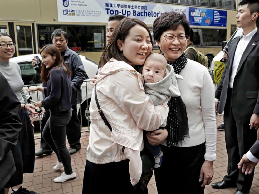 Hong Kong’s Chief Executive-elect Carrie Lam (right) with local residents in Hong Kong on Monday. Mrs Lam will be the city’s first ever female leader on July 1. Photo: AP