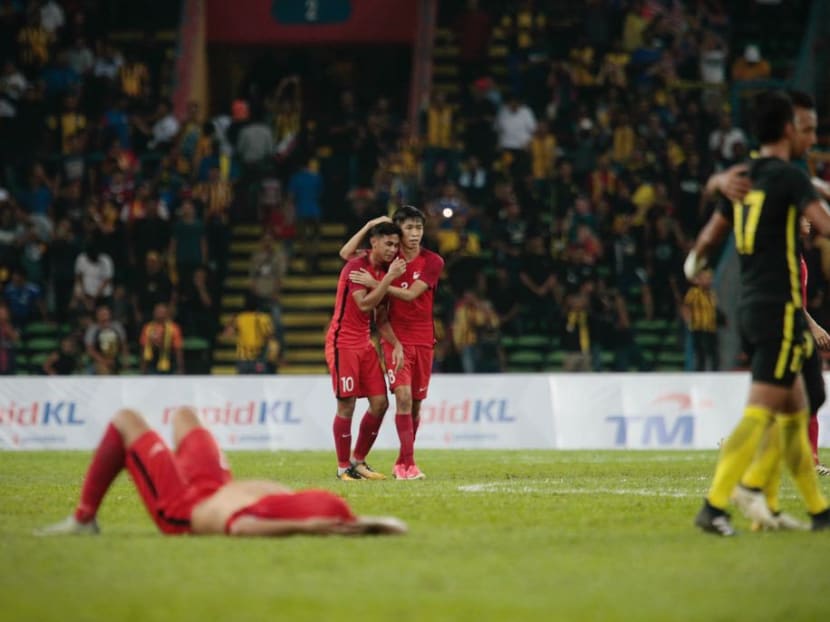 Singapore players (in red) react after losing to Malaysia at the SEA Games. Photo: Jason Quah/TODAY