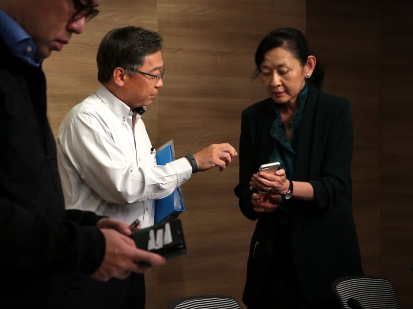 (Left) Minister for Health Gan Kim Yong speaks to Professor Ivy Ng, SingHealth group CEO, following a press conference on Friday, July 20, 2018.