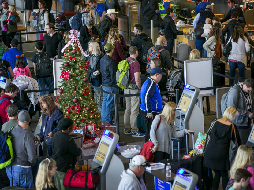 A Christmas tree is surrounded by travellers at Austin-Bergstrom International Airport in Austin, Texas, on Thursday, Dec 22, 2016. Photo: AP