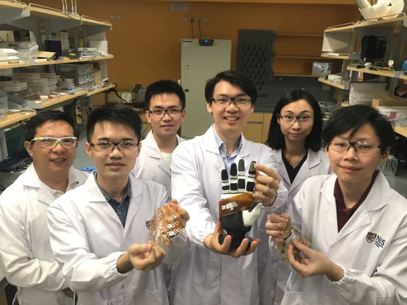 Assistant Professor Benjamin Tee (third from right) and some members of his National University of Singapore team, who have developed sensitive electronic skin that could be in commercial use in machines within two years. Assistant Professor Benjamin Tee (third from right) and some members of his National University of Singapore team, who have developed sensitive electronic skin that could be in commercial use in machines within two years.