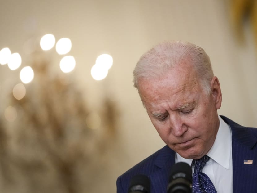 US President Joe Biden bows his head in a moment of silence as he speaks about the situation in Kabul, Afghanistan from the East Room of the White House on August 26, 2021 in Washington, DC.