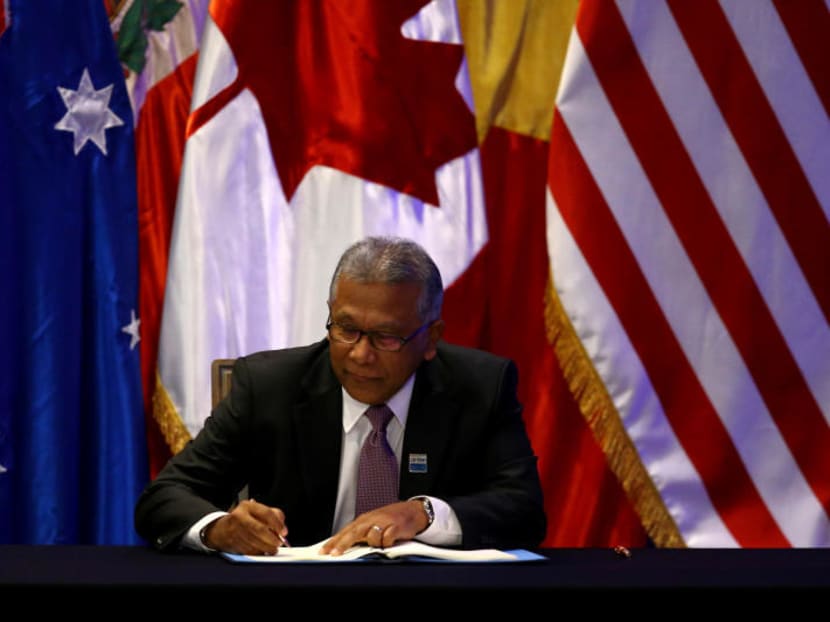 Malaysia's Minister for Trade and Industry J. Jayasiri signing the Comprehensive and Progressive Agreement for Trans-Pacific Partnership trade deal in Santiago. Photo: Reuters