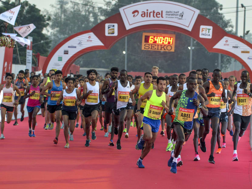 Athletes run from the start line during the 2019 Airtel Delhi half marathon in New Delhi on Oct 20, 2019.