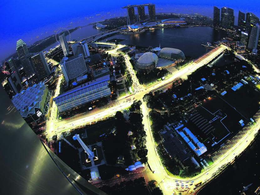 An aerial view at dusk shows the illuminated Marina Bay Street Circuit for the Singapore Formula One Grand Prix.